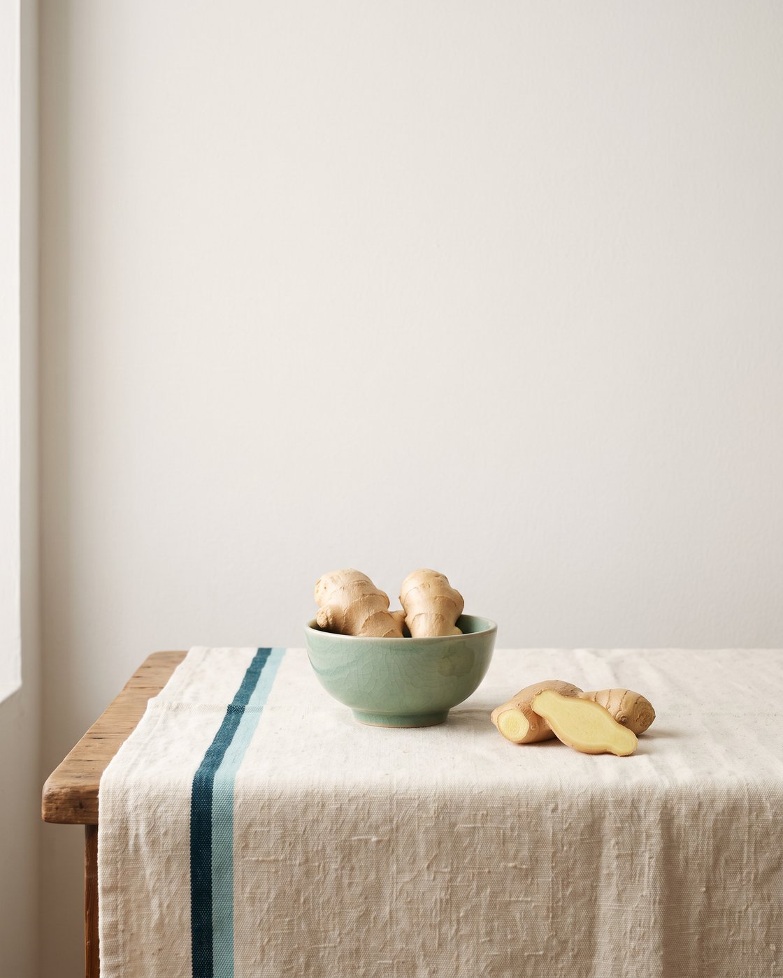 Fresh ginger on a warm plaster surface