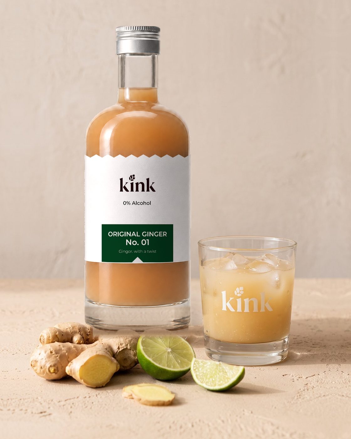 kink 510ml bottle beside a glass of kink over ice, with fresh ginger and lime